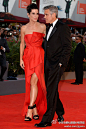#明星礼服欣赏#桑德拉·布洛克 (Sandra Bullock) 与乔治·克鲁尼 (George Clooney) 亮相2013年威尼斯电影节开式红毯，橘红色前短后长礼服搭配黑色鞋子，你觉得怎么样啊？