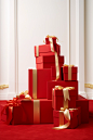 In this illustration, red boxes with ribbon on top of them, in the style of large-scale photography, elegant compositions, carpetpunk, xmaspunk, minimalist still lifes, light white and gold, lively interiors