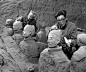 1974年，秦始皇陵兵马俑在陕西临潼县西杨村被发现，此后挖掘工作陆续展开。图为1979年7月11日，考古工作者在仔细发掘清理陶俑。