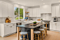 Inspiration for a mid-sized transitional u-shaped light wood floor and beige floor open concept kitchen remodel in Seattle with an undermount sink, shaker cabinets, dark wood cabinets, quartz countertops, white backsplash, porcelain backsplash, stainless 