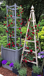 Tower obelisk with planter painted Deep Lead with red roses at RHS Chelsea Flower Show 2017