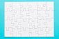 Elevated view of white jigsaw puzzle grid on blue surface