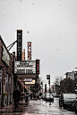 Person Walking Beside Gray Building