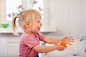 Toddler girl washing her hands图片素材