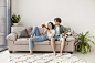 full-shot-couple-sitting-couch