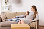 pregnancy-people-family-concept-happy-pregnant-woman-with-girl-sitting-sofa-home