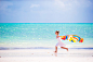 Little girl have fun with beach towel during tropical vacation by Dmitry Travnikov on 500px
