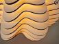 This may contain: the light fixture is shaped like waves