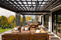 Example of a farmhouse tile patio design in New York with a pergola