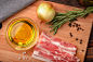 Raw bacon, olive oil, spices and herbs