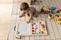 full-shot-kid-playing-with-colorful-wooden-toys