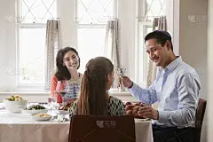 犹太男子在安息日拿着童装杯祝福他的家人