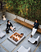 modern backyard stone patio with fire