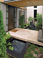 Modern Front Entry with Pocket Garden : To reach the custom wenge front door, guests traverse a concrete bridge with stone facing by Emil&#;39s Concrete in Redmond and Oregon Tile & Marble, and pass a "pocket garden" with a koi pond (als