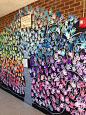 collaborative mural on side of the lower pod with all the students hands.. trunk and swirls black: