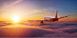 Passengers commercial airplane flying above the clouds in sunset light