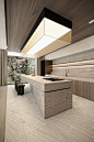 This may contain: a modern kitchen with an island countertop and wooden cabinetry, along with two stools