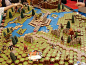Heroscape • This Fantasy Battle Board Game comes with dozens of painted plastic miniatures, each representing a warrior from a different era, and hex-based hard plastic terrain pieces which can be put together in many different ways. The warriors include 
