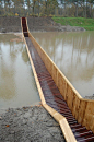 Creative pedestrian bridge near Fort de Roovere in the Netherlands divides the water like Moses and allows people to safely cross to the other side.