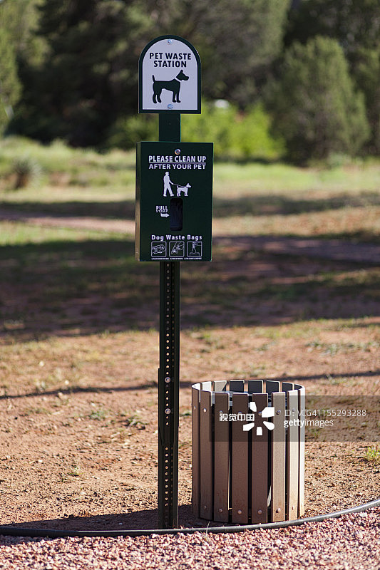 A sign and bin for p...