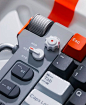 This may contain: an orange and gray computer keyboard with some red and white keys on it's side
