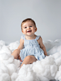 joblessjaymob7019_A_cute_baby_sitting_and_playing_on_a_white_cl_cb507500-e73c-4253-9171-17785ec5e086