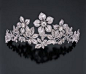 A DIAMOND TIARA. In the garland style, designed as a rose-cut and oldmine-cut diamond flower spray with three oldmine-cut and rose-cut diamond "en tremblant" flowerheads, each set with an old european-cut diamond weighing 2.22, 2.61 and 3.21 car