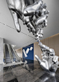 This may contain: a large metal sculpture in the middle of a lobby with an escalator next to it