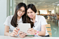 Prasit Rodphan在 500px 上的照片Two Asian student with uniform in classroom with electronic tabl