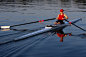 Person rowing sculling boat on river - stock photo