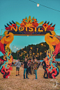 This may contain: people are standing under a sign that says notsly in front of an open field