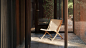 Photograph showing rattan and wooden chair in glazed garden room[主动设计米田整理]