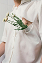 Man in White Button-up Shirt With White Flowers