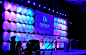 Cylindrical shapes with colorful LED lighting variations add texture to any event backdrop. Great stage idea!