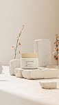 Beige Colored Beauty Facial Cream Product on Naturalistic Granite Stone Product Stand Display with Small Flower Decoration Ecommerce Story