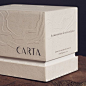 其中可能包括：two white boxes sitting on top of a wooden table next to each other with the words carta printed on them