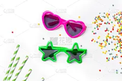 儿童太阳镜在明亮的颜色和各种形式的白色背景与派对配件。孩子的政党概念