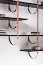 Design LucidiPevere Thin perpendicular supports fall from the ceiling to be anchored to the wall in delicate curves. Like climbing vines, they create a new kind of suspended architecture. Each branch becomes a support for one or more shelves in a modular 