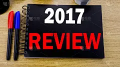 概念手写文本说明显示2017年回顾。年度总结报告的经营理念写在便利贴上，以旧木为背景，以太阳镜为背景