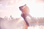Young woman dancing at sunny poolside party by Caia Images on 500px