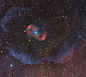 NGC 6164的外暈  美麗的發射星雲NGC 6164，是由一顆質量約40倍太陽的稀有熾熱明亮O型恆星所造成的。 位在星雲中心的這顆恆星，年齡介於3百萬至4百萬年之間，而再過3到4百萬年，即將以超新星爆炸的形式結束它的生命。 影像中央這團具有雙極瓣對稱外觀的星雲，大小約為4光年，外形酷似較常見的行星狀星雲 ─ 一種環拱濱死類太陽恆星的氣殼。
.