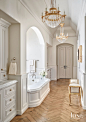 Chevron Herringbone Master Bathroom with Two Crystal Chandeliers and Bench : The sumptuous master bath features two Niermann Weeks chandeliers and a Panache bench. Oiled herringbone floors balance the glitz.