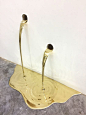 In this ongoing body of sculptural works, Brazillian artist Vanderlei Lopes creates temporary interventions where his polished brass objects appear to pour and drain like gold from the walls or floors of galleries. Much of Lopes' work plays with aspects o