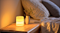 gvnfc_Bed_bedside_table_white_walls_light_yellow_light_night_cl_4294ce79-9e0e-4436-80b1-98aad6e80652
