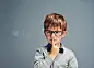 Question everythingStudio shot of a smartly dressed little boy looking thoughtful against a gray background