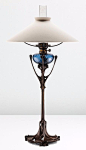 HECTOR GUIMARD Rare table lamp, from the Maison Coilliot, Lille, circa 1900,patinated bronze, colored blown glass, clear glass chimney, painted brass, brass, fabric shade, 38 3/4 in. | SOLD $80,500 Phillips New York, Dec. 16, 2014