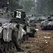 An Israeli soldier smokes a cigarette next to a convoy of tanks at an Israeli army deployment area near the Israel-Gaza Strip border as they prepare for a potential ground operation in the Palestinian coastal enclave, November 19, 2012. (Menahem Kahana/AF