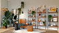 brown and black armchair beside white wooden shelf