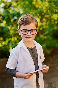 With all this exploring, I'm sure to discover somethingPortrait of an adorable little boy pretending to be a scientist by exploring the plants outside using a tablet