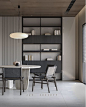 This may contain: a table and chairs in a room with bookshelves